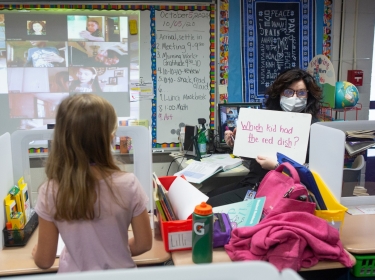 Second-grade teacher with white board, photo by Allison Shelley for EDUimages/<a href="https://images.all4ed.org/license">CC BY-NC 4.0</a>