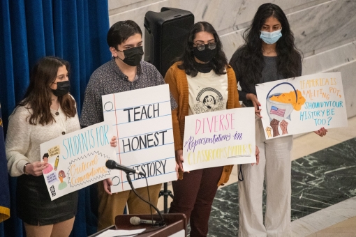 Students hold signs inside the Kentucky Capitol Rotunda in opposition to bills Kentucky lawmakers say would eradicate critical race theory from state schools, January 12, 2022