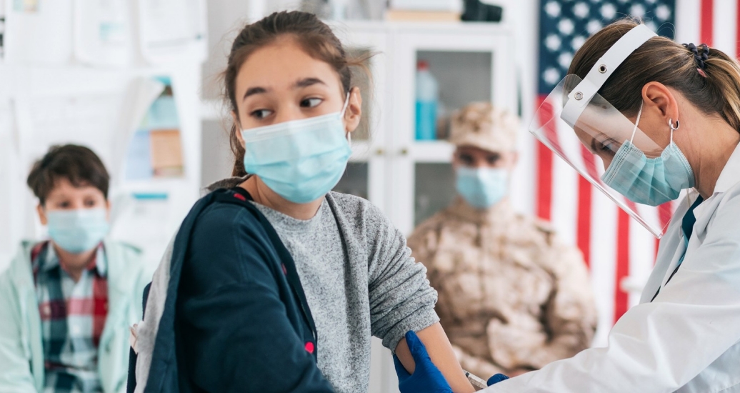 A girl getting a COVID-19 vaccination