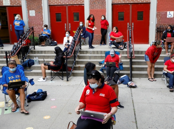 Teachers work outside their school building for safety reasons as they prepare for the delayed start of the school year due to COVID-19, in Brooklyn, New York City, September 14, 2020, photo by Brendan McDermid/Reuters