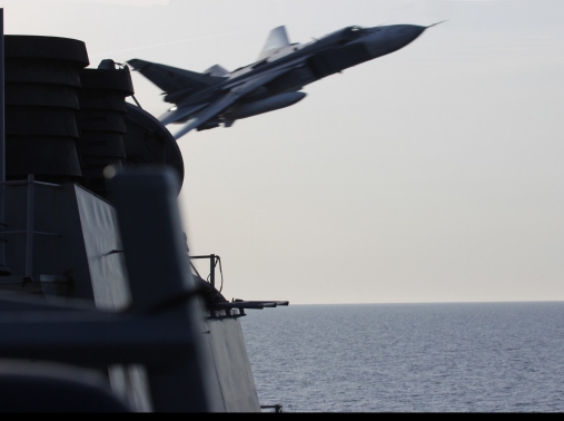 A Russian Sukhoi Su-24 attack aircraft makes a very low-altitude pass by USS Donald Cook, April 12, 2016