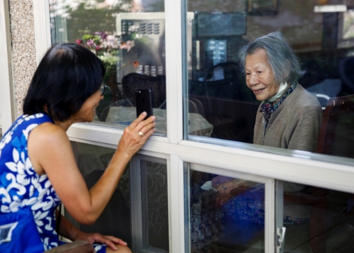 Su Wilson visits her mother Chun Liu, a resident at the Life Care Center of Kirkland, a long-term care facility linked to several COVID-19 deaths in Kirkland, Washington, May 10, 2020