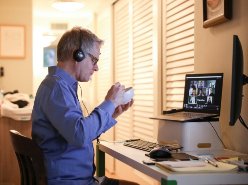 Doug Hassebroek eats breakfast while on a video conference call at his home in Brooklyn, April 24, 2020