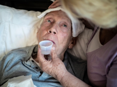 Elderly man drinking medicine, photo by LPETTET/Getty Images