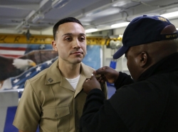 Lt. Brendan Shields, assigned to Pre-Commissioning Unit Gerald R. Ford (CVN 78), is pinned to the rank of lieutenant by Chief Warrant Officer Tony Cochran during a promotion ceremony on Ford's fo c'sle, photo by Chuck Little / Alamy Stock Photo