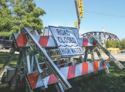 Traffic barriers with a sign reading "Road Closed High Water" on the roadside near Washington Boulevard, Pittsburgh, PA. Photo by Jordan Fischbach / RAND Corporation