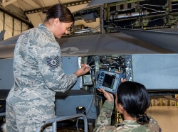 Tech. Sgt. Rosa Valdes and Staff Sgt. Rebecca Toland, non-destructive inspection technicians from the 140th Maintenance Squadron, perform an inspection of the 446 bulkhead on a block-30 F-16 Fighting Falcon aircraft. The 446 bulkhead is aft fuselage structure of the F-16 aircraft that supports the tail structure and recent tests have indicated an increased amount of stress cracks in this area, photo by Senior Master Sgt. John Rohrer/U.S. Air National Guard