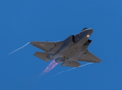 F-35 Lightning II approaching with afterburner on and condensation trails at the wings tip, photo by rancho_runner/Getty Images/iStockphoto