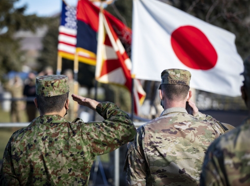  A Japan Ground Self-Defense Force soldier (left) and a U.S. Army soldier (right) salute the Japanese and U.S. flags during the opening ceremony of Rising Thunder 2021 at Yakima Training Center, Washington, December 1, 2021