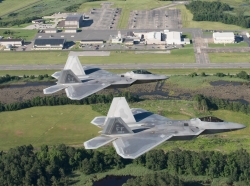 Two U.S. Air Force F-22 Raptors fly over Joint Base Langley-Eustis’ Felker Army Airfield at Fort Eustis, Virginia, June 12, 2018. Felker Army Airfield represents the success of consolidating Army and Air Force operations through a joint base as the airfield continues to support aerial missions while being operated by the Air Force’s 1st Operations Support Squadron, photo by Tech. Sgt. Natasha Stannard/U.S. Air Force