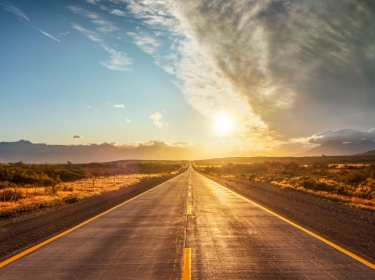 Highway headed toward the sun, photo by DieterMeyrl/Getty Images