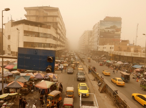 Traffic moves slowly as crowds gather at the Shorja wholesale market during a sandstorm in Baghdad, Iraq, July 3, 2022