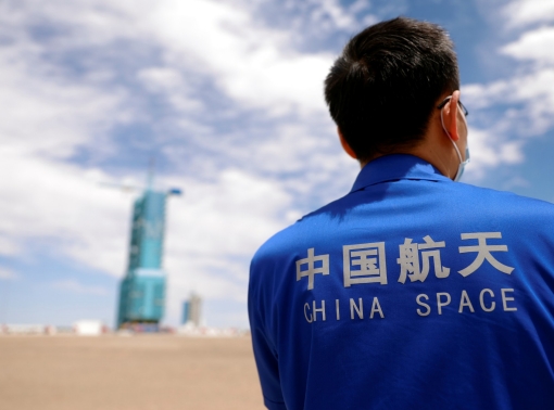 A staff member stands in front of the launchpad at Jiuquan Satellite Launch Center ahead of the Shenzhou-12 mission to build China's space station, near Jiuquan, Gansu Province, China, June 16, 2021, photo by Carlos Garcia Rawlins/Reuters
