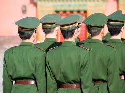 Unrecognizable group of soldiers standing in line and seen from behind. Wearing uniforms including caps. The soldiers belong to the Chinese armed forces, photo by FrankvandenBergh/AdobeStock