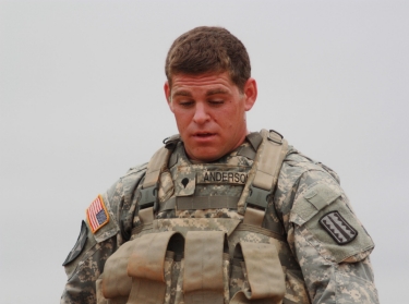 Spc. Luke Anderson is fatigued after marching six miles in full combat gear with body armor, a 50-pound rucksack and a basic load of ammunition for his weapon. On this day, he also carried the heavier weapon, the M249 SAW.