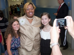 A Maryland elementary school principal poses for a photo with two fifth graders.