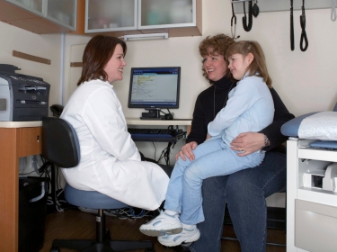 A nurse practitioner discusses care with a patient and her mother at the Take Care Health Clinic, one of 21 in the Chicago, Illinois area