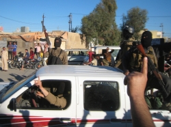 Al Qaeda fighters celebrate on vehicles taken from Iraqi security forces in Fallujah, March 20, 2014