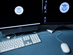 The logos of the U.S. Department of Homeland Security are seen on computer terminals