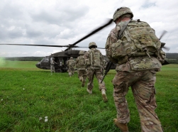 U.S. Army soldiers board a UH-60 Black Hawk helicopter at the Joint Multinational Training Command's Grafenwoehr Training Area in Germany, August 13, 2013