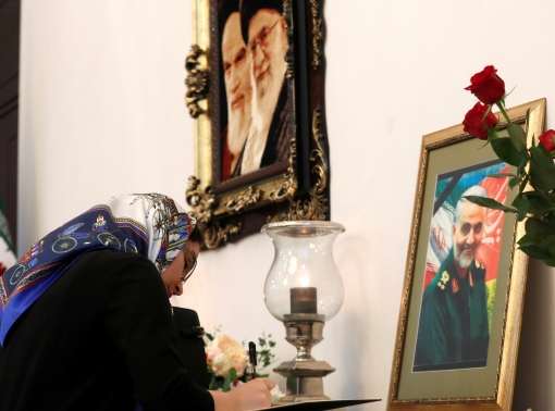 A woman signs a condolence book for Iranian Major-General Qassem Soleimani at the Iranian embassy in Minsk, Belarus, January 10, 2020