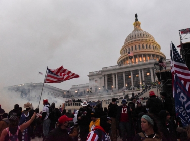Police clear the U.S. Capitol Building with tear gas as supporters of then-President Donald Trump gather outside, in Washington, January 6, 2021, photo by Stephanie Keith/Reuters