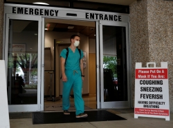 Dennis D'Urso, a resident ER doctor at Holy Cross Hospital, leaves work after his shift amid an outbreak of COVID-19, in Fort Lauderdale, Florida, April 20, 2020, photo by Marco Bello/Reuters
