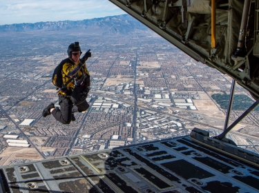 Army Sgt. 1st Class Cory Christiansen, a member of the Para-Commandos, U.S. Special Operations Command’s parachute team, jumps out of an HC-130J Combat King II aircraft over Nellis Air Force Base, Nev., Nov. 15, 2019, photo by Air Force Airman 1st Class Dwane Young/U.S. Department of Defense