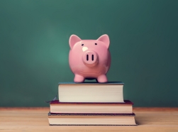 Piggy bank and school books in a classroom