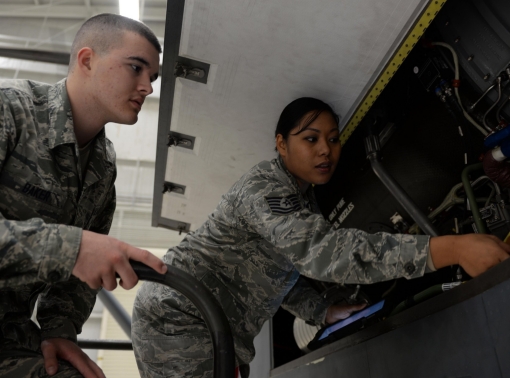 A maintenance instructor points out features of a remotely piloted aircraft