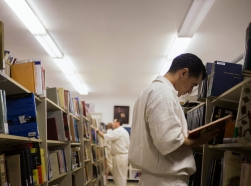 Inmates search for books at a library inside the Southwestern Baptist Theological Seminary located in the Darrington Unit of the Texas Department of Criminal Justice men's prison in Rosharon, Texas, August 12, 2014