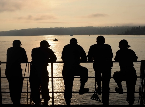 Sailors at the railing on the USS John C. Stennis