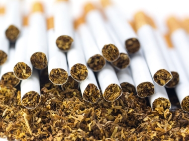 Filter cigarettes on a heap of loose tobacco, Photo by Maren Winter info@maren-winter.de/Adobe Stock