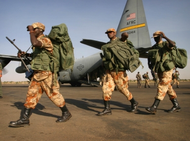 Rwandan troops arrive on a U.S. Air Force C-130 cargo plane at El Fasher airport in Darfur, as part of an African Union peacekeeping effort in western Sudan, October 30, 2004, photo by Finbarr O'Reilly/Reuters