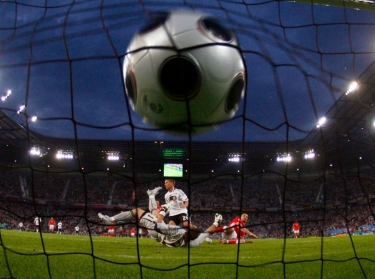 Germany's Lukas Podolski scores past Poland's goalkeeper Artur Boruc at the Woerthersee Stadium in Klagenfurt, Austria, June 8, 2008