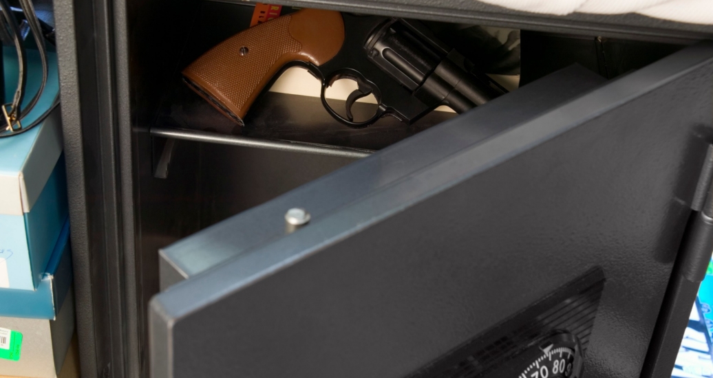 A open door of a safe showing a hand gun stored inside