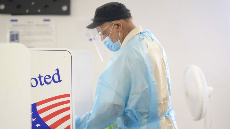A poll worker disinfects booths after every use during early voting in Knoxville, Tennessee, July 17, 2020, photo by Cavin Mattheis/News Sentinel