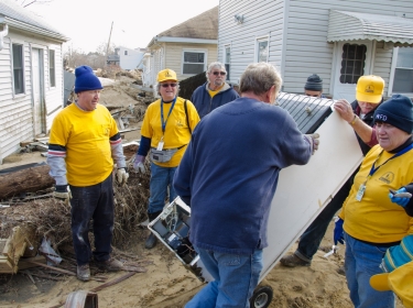 Volunteers from the North Carolina Southern Baptists help clean out some apartments that were flooded during Hurricane Sandy. Photo by Liz Roll/FEMA