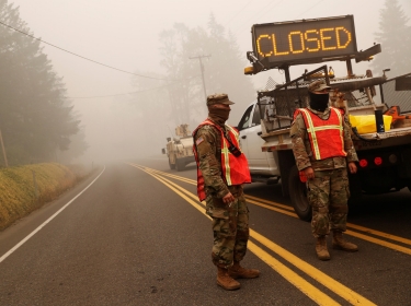 Members of the Oregon Army National Guard block access to Route 22 in the aftermath of the Beachie Creek fire in Gates, Oregon, September 14, 2020, photo by Shannon Stapleton/Reuters