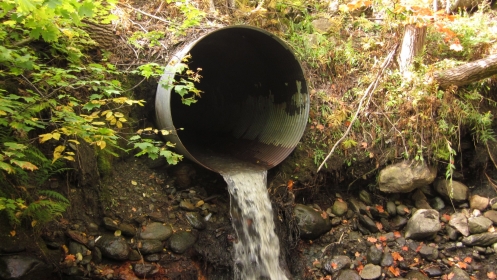 Culvert with a drop, with flowing water