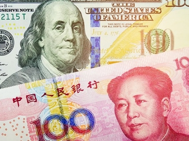 Close up of the U.S. dollar and Chinese yuan bills