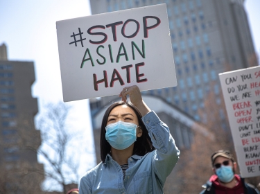 A woman participates in a Stop Asian Hate rally at Columbus Park in New York City, April 3, 2021, photo by Jeenah Moon/Reuters